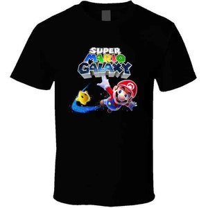 May include: Black t-shirt with a graphic of Mario from Super Mario Galaxy. The graphic features Mario in a space suit with a yellow star and the text "Super Mario Galaxy".