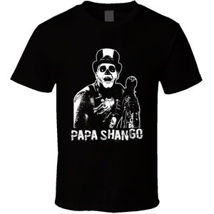 May include: Black t-shirt with a white graphic of a skeleton wearing a top hat and holding a staff. The text "Papa Shango" is printed below the graphic.