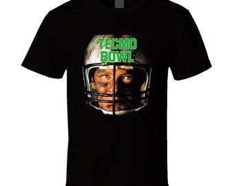 May include: Black t-shirt with a graphic of a football player wearing a helmet. The text "Tecmo Bowl" is printed in green on the helmet.