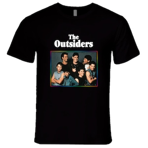 May include: Black t-shirt with a white graphic of the movie "The Outsiders" featuring a group of young men.