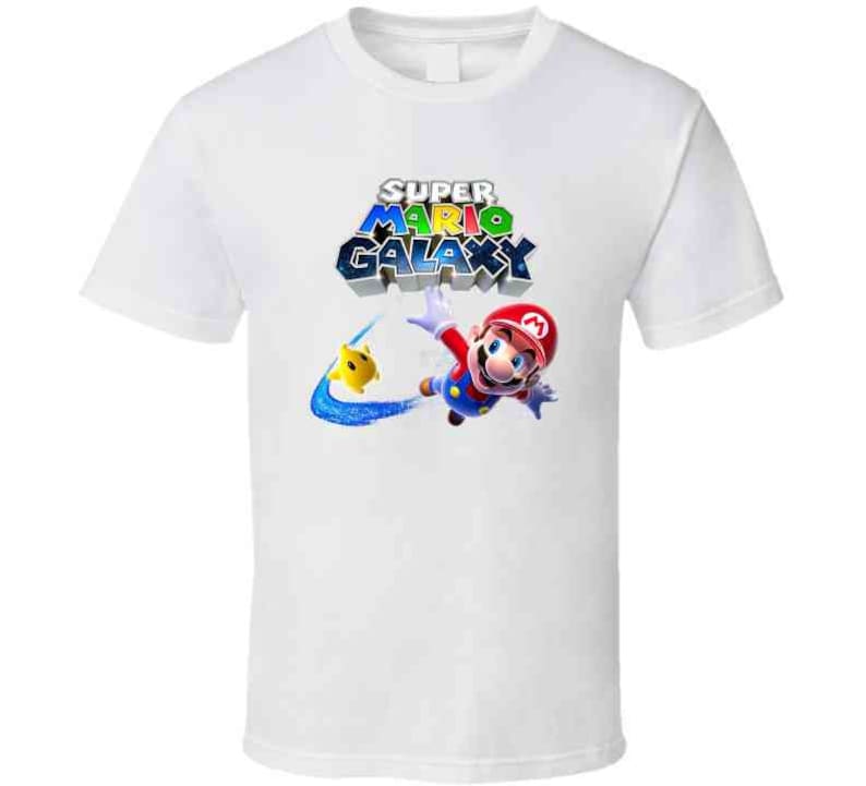 May include: White t-shirt with a colorful Super Mario Galaxy logo and a graphic of Mario flying through the air.