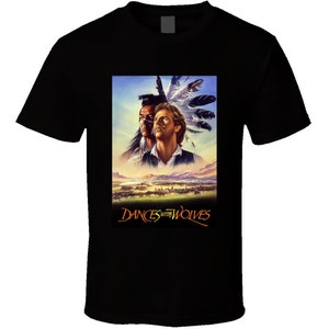 May include: Black t-shirt with a graphic print of the movie poster for Dances with Wolves. The poster features two men, one Native American and one Caucasian, with a landscape background.