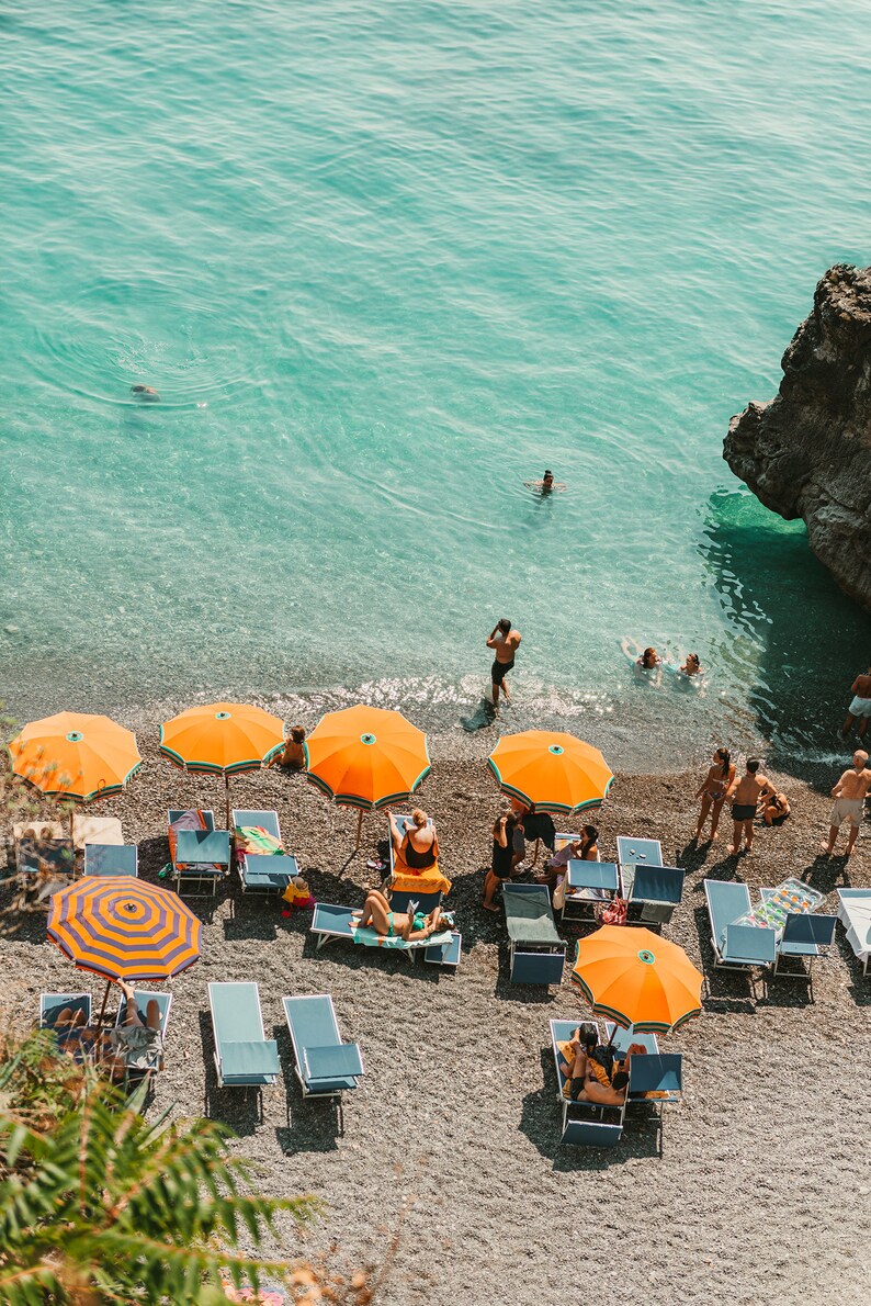 vintage beach print of Positano in Italy with ocean and orange umbrellas in a digital download printable format