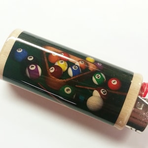 May include: A wooden lighter with a green felt pool table design. The lighter features a printed image of a pool table with billiard balls numbered 1 through 15.