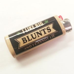 May include: A wooden lighter with a black and green label that says "I like big blunts and I cannot lie".