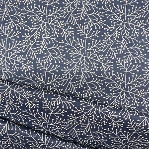 May include: A navy blue fabric with a white floral pattern. The pattern features small white dots and delicate branches.