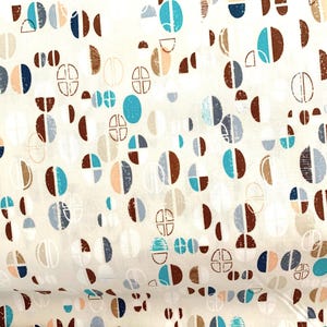 May include: White fabric with a repeating pattern of brown, blue, and peach geometric shapes. The shapes are circles, half circles, and squares.