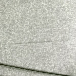 May include: Close-up of a light gray fabric with a textured, woven appearance. The fabric has a subtle grid pattern created by the interwoven threads. The fabric is folded, revealing its texture and drape. Ideal for upholstery or apparel.