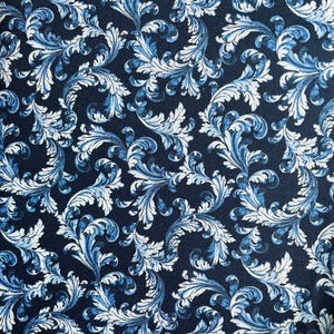 May include: A navy blue fabric with a white and blue floral pattern. The pattern features intricate swirls and leaves.