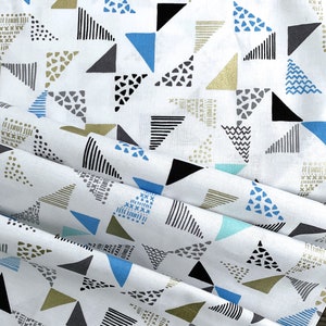 May include: White fabric with a repeating pattern of blue, black, gray, and gold triangles. The triangles are filled with different patterns, including dots, stripes, and zigzags.