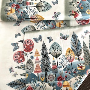 May include: Fabric with a whimsical forest design. The pattern features stylized trees, flowers, and butterflies in shades of blue, red, yellow, and green against a white background. The fabric is folded, showing the repeating pattern.