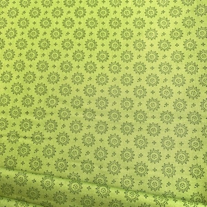 May include: Green fabric with a repeating pattern of small black circles arranged in a circular design.