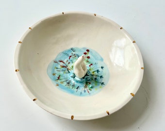 SECONDS: Porcelain bowl with figure jumping into a lake of flowers and fish