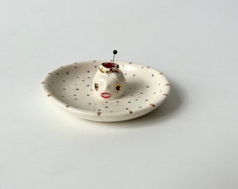 SAMPLE: little polkadot pin-cushion dish with a tiny head with a crown and red lips