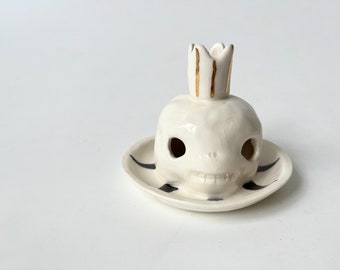 Porcelain candleholder, in the shape of a skull with a crown, with real gold