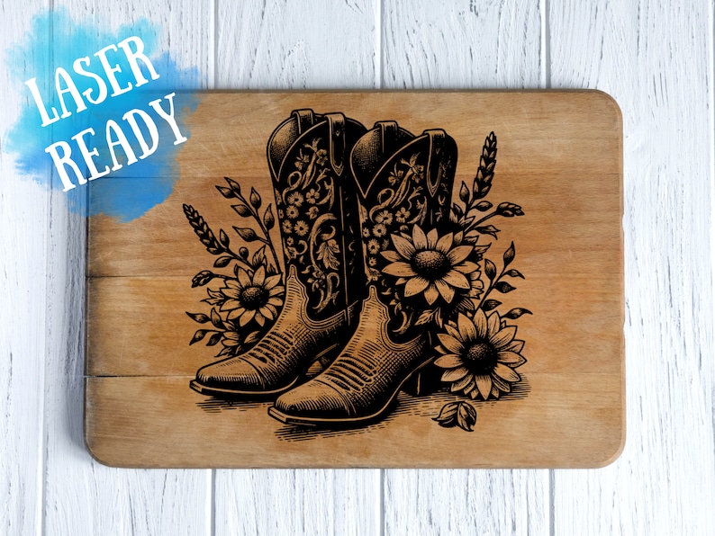 May include: Wooden cutting board with a laser-etched design of cowboy boots and sunflowers. The boots are intricately detailed, and the sunflowers and foliage add a decorative touch. The words "LASER READY" are in the upper left corner.