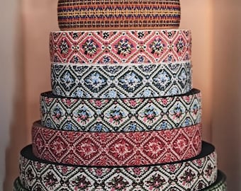 May include: A stack of eight colorful elastic bands with geometric patterns. The bands are arranged in a pyramid shape, with the largest band at the bottom and the smallest band at the top. The bands are made of a soft, stretchy material and are perfect for adding a touch of color and style to any project.