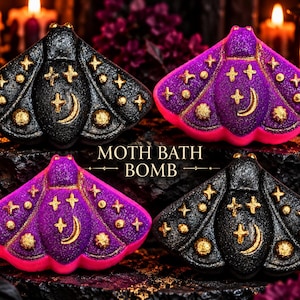 May include: Four moth-shaped bath bombs in black and purple with gold glitter accents. Each bath bomb features embossed celestial designs including stars and a crescent moon. The text MOTH BATH BOMB is centered between the items in gold lettering.
