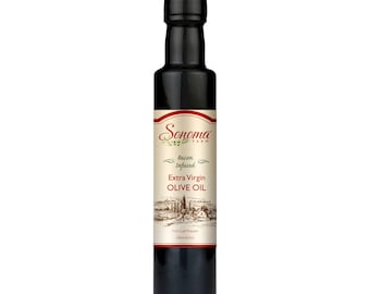 May include: A glass bottle of Sonoma Farm Bacon Infused Extra Virgin Olive Oil. The bottle is dark green and has a white label with a drawing of a country road and a farmhouse. The label also says "First Cold Pressed" and "250ml (8.5 fl oz)".