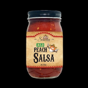 May include: A glass jar of Sonoma Farm Mild Peach Salsa with a black lid. The label features a cartoon peach character wearing a cowboy hat and bandana, holding a bottle and a pistol. The text reads Sonoma Farm, MILD, PEACH, SALSA, 16oz. (473ml).