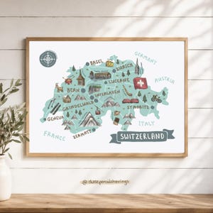 May include: A framed illustrated map of Switzerland featuring a light blue landmass, a compass rose, and various hand-drawn icons representing cities like Zurich, Bern, and Geneva, alongside landmarks, mountains, and the text SWITZERLAND.