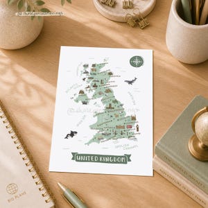 以下が含まれることがあります： 緑色のランドマークと都市のイラストが描かれた、イギリスの装飾地図。「UNITED KINGDOM」の文字が下にあります。地図は白い紙にあり、右上には羅針盤があります。