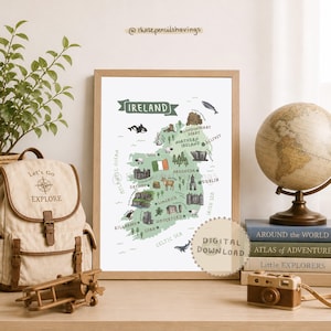 Może przedstawiać: Oprawiona mapa Irlandii z ilustracjami zabytków i zwierząt. Mapa jest w jasnej drewnianej ramie i zawiera napis "Ireland" na górze. Plecak, globus, książki i zabawkowy aparat fotograficzny znajdują się na pierwszym planie.