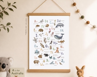 May include: A framed educational poster featuring an Australian animal alphabet. The poster displays colorful illustrations of animals like koalas, kangaroos, and wombats, each paired with a letter of the alphabet. The poster is suspended by a wooden frame.