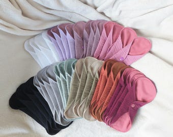 Juego de 4 protectores diarios grandes de muselina de algodón, reutilizables, sostenibles, en varios colores.