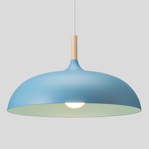 May include: A dome-shaped pendant light fixture featuring a matte light blue exterior finish and a pale green interior. The lamp includes a cylindrical light-colored wooden connector at the top, attached to a thin white cord for ceiling suspension.
