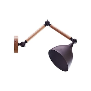 May include: A wall-mounted lamp with a dark grey shade and wooden arms. The lamp's shade is cone-shaped, and the arms are made of light-coloured wood. The lamp is designed to be adjustable, with multiple pivot points for positioning.