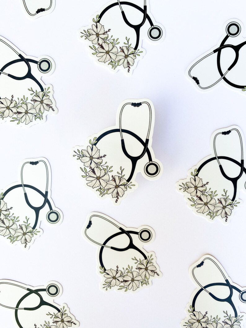 May include: Multiple black and white stickers featuring a stethoscope with white flowers around it. The stickers are on a white background.