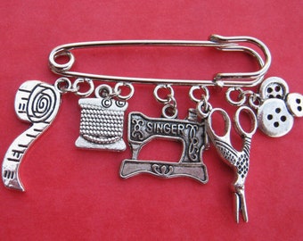 Silver tone kilt pin brooch  - 5 sewing themed charms - 50mm/2 inches long - can be used as lapel, scarf, hijab or bag pin