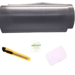 May include: A roll of gray carbon fiber vinyl wrap with a squeegee, a utility knife, and alcohol prep pads.