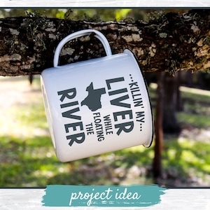 May include: White enamel camping mug with a black and gray design. The mug features the text "Killin' my Liver While Floating the River" and an outline of the state of Texas.