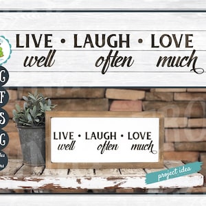 May include: A wooden framed sign with the words "LIVE LAUGH LOVE" in black script, with the words "well, often, much" below. The sign is on a white distressed wooden surface with a metal bucket and greenery. The image also includes the text "Cut Files for Crafters".