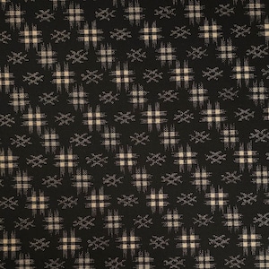 May include: Black fabric with a repeating pattern of tan and white geometric shapes. The design features a grid-like arrangement of squares and cross-like elements, creating a textured appearance. The overall aesthetic is a blend of modern and traditional styles.