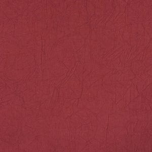 May include: A close-up shot of a textured, deep red fabric. The material has a crinkled appearance with subtle variations in tone, creating a sense of depth and visual interest. The fabric's surface is evenly lit, highlighting its unique texture.