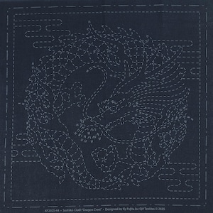 May include: A dark blue fabric with a white stitched design of a dragon crest. The fabric is labeled "Sashiko Cloth "Dragon Crest" Designed by Ky Fujita for QH Textiles © 2025"