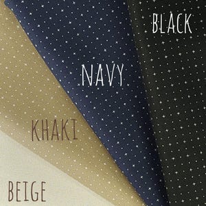 May include: Close-up of fabric swatches in beige, khaki, navy, and black. Each fabric has a pattern of small white crosses. The words "Navy", "Khaki", and "Black" are written on the fabric.