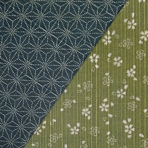 May include: Close-up of two fabric patterns. One is a dark teal with a white geometric design. The other is a green fabric with white floral patterns and vertical stripes. The fabrics are divided diagonally.