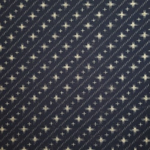 May include: A dark blue fabric with a white cross pattern. The fabric has a subtle texture and a slightly faded look.