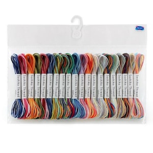 May include: A clear plastic hanging package containing twenty individual skeins of Sashiko thread in a variety of colors. Each skein is wrapped with a white paper label printed with the text Sashiko Thread and 100m, arranged in a horizontal row.