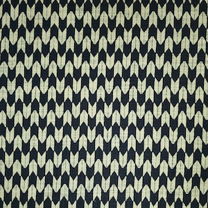 May include: A black fabric with a white chevron pattern. The pattern is made up of small, pointed shapes that are arranged in a repeating pattern.
