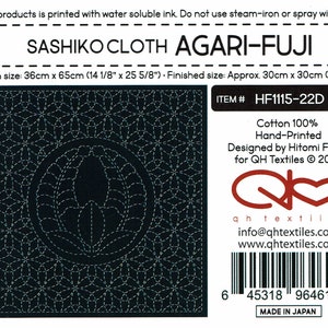 May include: Sashiko cloth embroidery pattern with a navy blue background. The pattern is called "Agari-Fuji" and is designed by Hitomi Fujita for QH Textiles. The cloth size is 14 1/8 inches by 25 5/8 inches and the finished size is 12 inches by 12 inches. The pattern is printed with water soluble ink.  The item number is HF1115-22D.