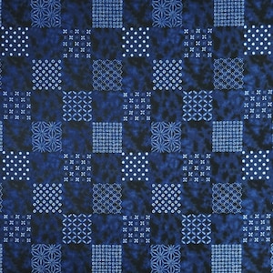 May include: A seamless pattern with a dark blue tie-dye background. The design is a grid of squares, each with a different pattern in white and blue. These include dots, crosses, and geometric shapes. The overall effect is a textured, repeating design, suitable for fabric or wallpaper.
