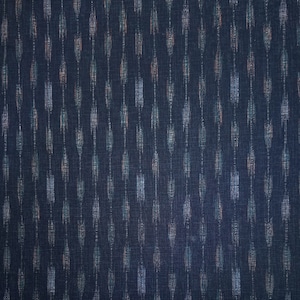 May include: A dark blue fabric with a white and light blue ikat pattern.