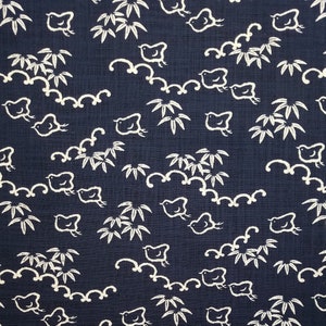 May include: A dark blue fabric with a white repeating pattern of birds and bamboo leaves. The pattern is a traditional Japanese design.