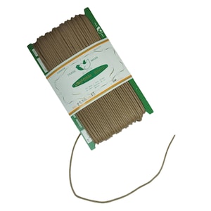 May include: A spool of brown uniform braid cord. The label reads "UNIFORM BRAID" with a bird logo and the text "SUPERIOR TRADE MARK QUALITY". The spool is wrapped in green and white packaging. The cord is approximately 50 meters long.