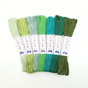 May include: Six spools of green embroidery floss, each with a label that reads "Kogyo Thread" and "こぎん糸" in Japanese. The colors range from light green to dark green.